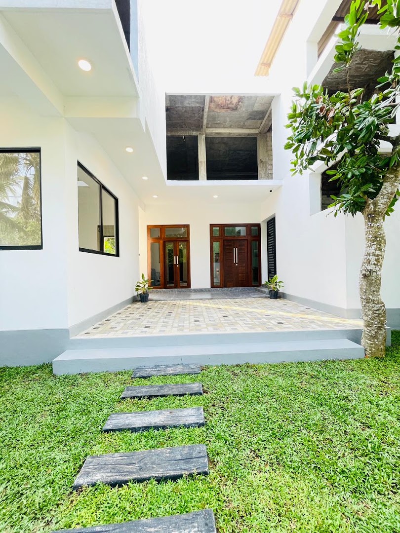 White villa courtyard with timber doors and garden steps