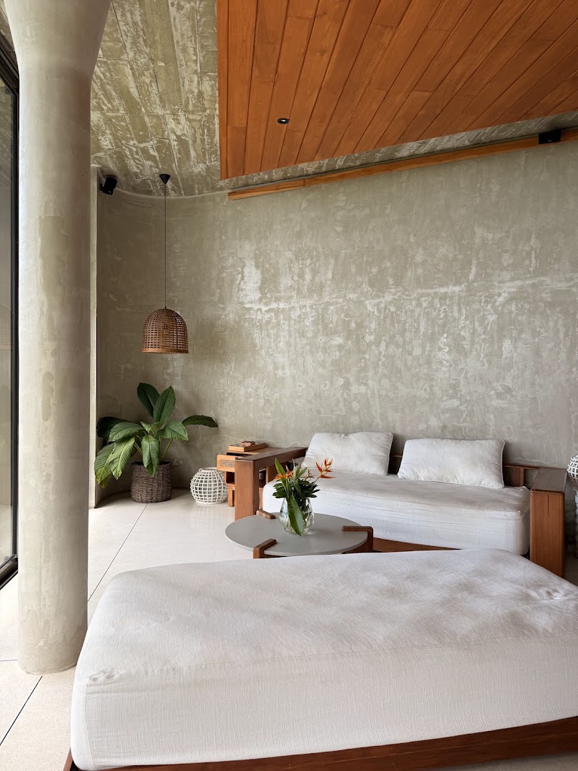 Bright interior with white seating and timber ceiling